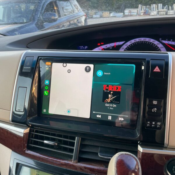 Car dashboard showing navigation and music playing "Get It On" by T. Rex.