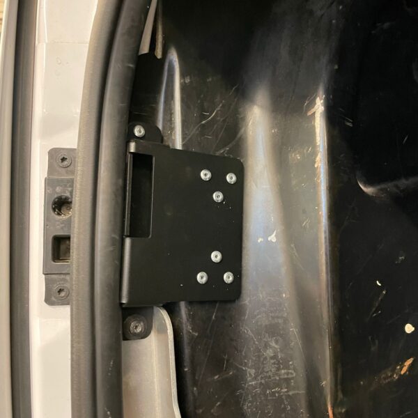 Close-up of a car's interior metal frame with a black metal bracket and rubber seal.