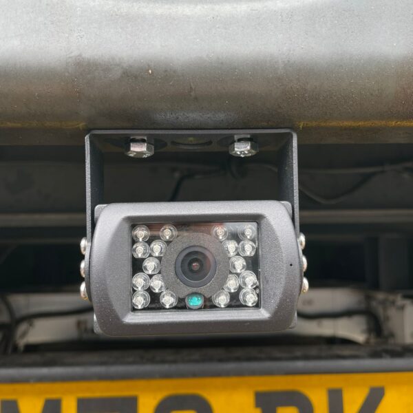 Close-up of a vehicle's rearview camera and license plate.